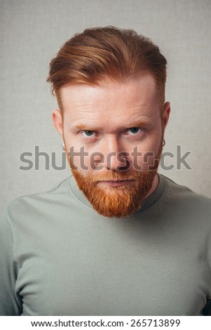 portrait of a Young red bearded Man feel bad, sad