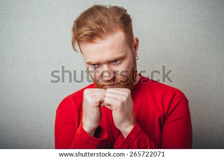 Young hipster red bearded Man with fist on his goatee