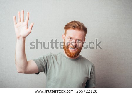 Young red bearded Man saluting