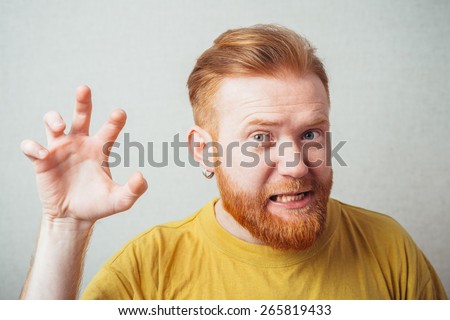 on a gray background man with a beard in a yellow T-shirt like a lion
