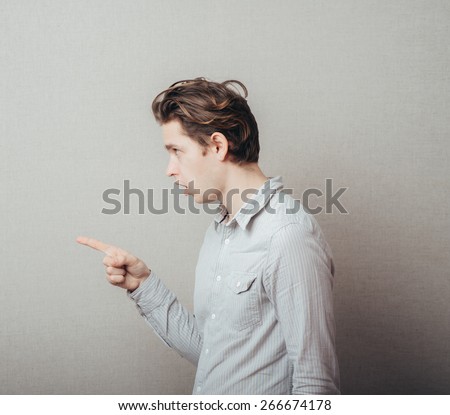 Portrait of a smart guy pointing to something