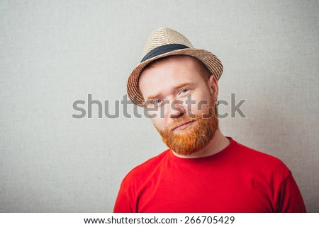 Portrait of handsome serious redhead man in hat