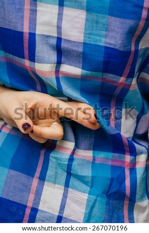 on a white background young girl crossed her fingers behind her back