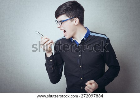angry young man while answering smart phone not understood
