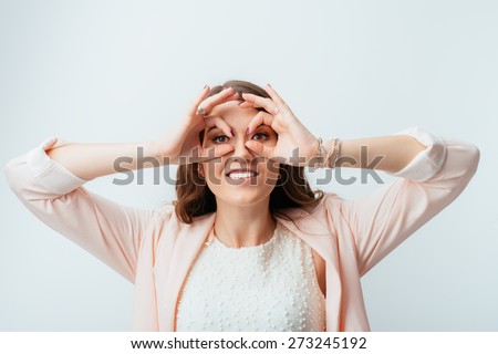 girl shows hands binoculars