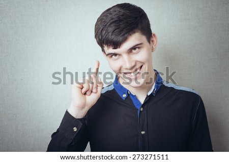 young man pointing up, showing something, having an idea
