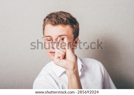 Isolated man holding something in fingers