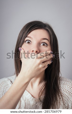 girl covers her mouth