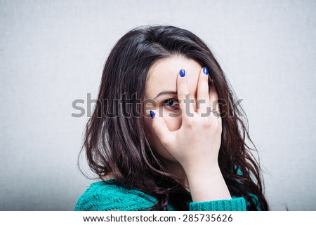beautiful woman closes one eye hand and has headache