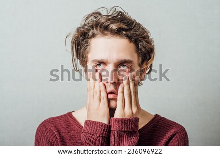 Closeup portrait, headshot young tired, fatigued business man worried, stressed, dragging face down with hands Negative human emotions, facial expressions, feelings