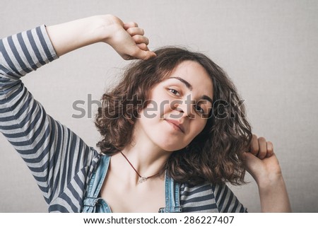 A woman wants to sleep, stretching. Gray background