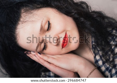 A woman wants to sleep. Gray background