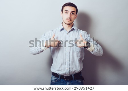 Male hand forefinger pointing to himself on the chest. Gesture. who am i. On a gray background