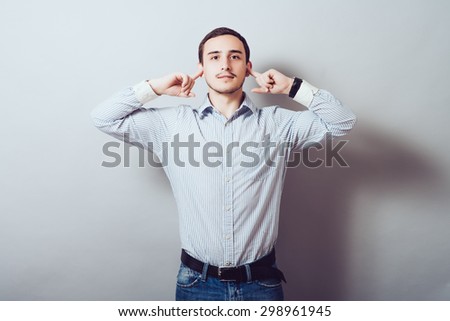 man covers his ears from the noise