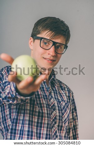 Cheerful beautiful man eating apple