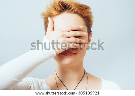 young girl covering her eyes