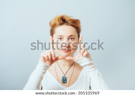 Beautiful woman making a hand frame