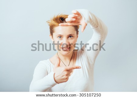 Beautiful woman making a hand frame