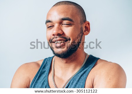 Portrait of a happy african man with closed eyes