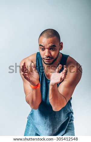 a dark-skinned man holding something delicate hands