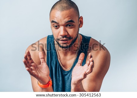 a dark-skinned man holding something delicate hands