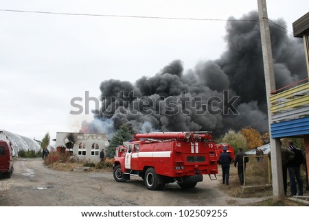 KHMELNITSKY, UKRAINE - OCTOBER 11: fire department in action during burning warehouses with plastic products, October 11, 2011 in Khmelnitsky, Ukraine