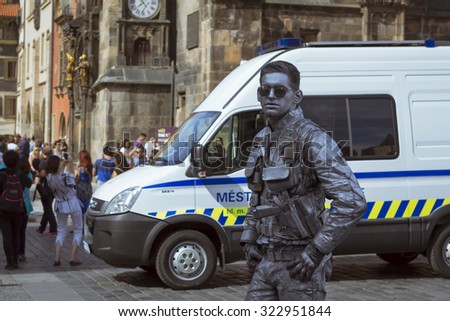 PRAGUE, CZECH REPUBLIC - AUGUST 27, 2015: Meme-artist in the uniform of futuristic policeman posing at the Old Town Square in the background of the Old Town Hall (Staromestska radnice) in Prague, Czech Republic