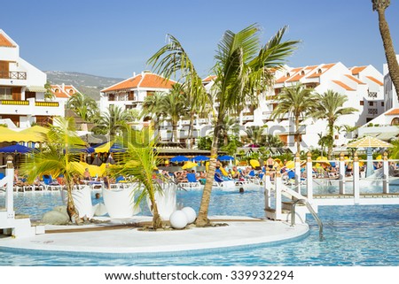 TENERIFE, SPAIN - JANUARY 17, 2013: Swimming pool, open-air restaurant and beach of luxury hotel, Playa de Las Americas, Tenerife, Canary Islands, Spain