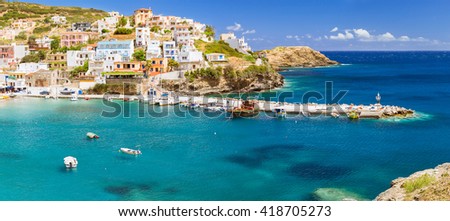 Harbour with marine vessels, boats and lighthouse. Panoramic view from a cliff on a Bay with beach Bali - vacation resort, with secluded beaches and clear ocean waters, Rethymno, Crete, Greece