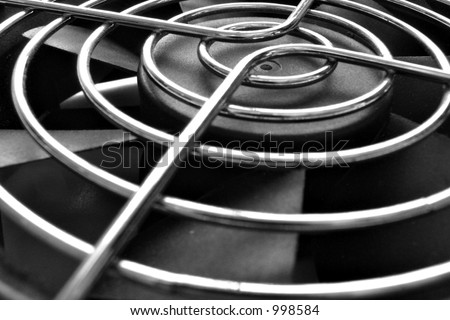 Close-up view of a computer cooling fan and fan grille.