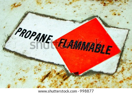 Warning sign on pressurized liquid propane tank showing \