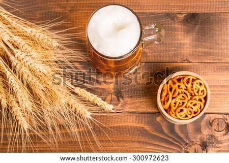 Oktoberfest Beer Mug and traditional German pretzels with wheat cones on the wood  table