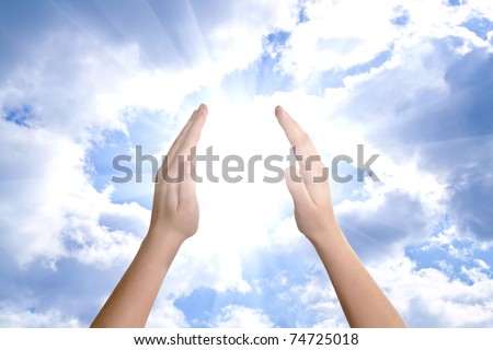 hand sun and clouds with copyspace showing freedom or solar power concept
