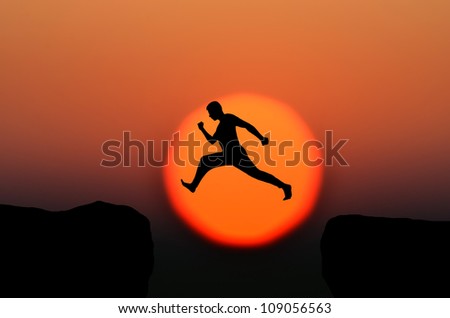 a man jumps from one rock to another