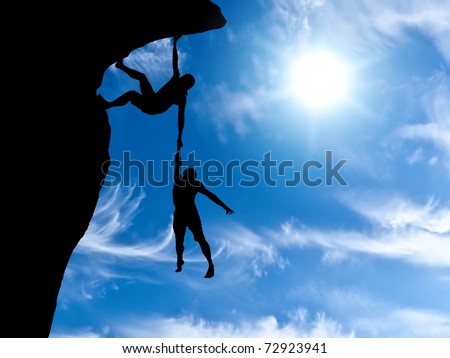 climber clings to a rock plummet with the other hand holding the man