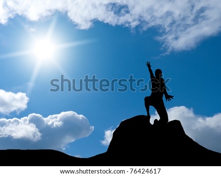 man at the top of the mountain against the sky