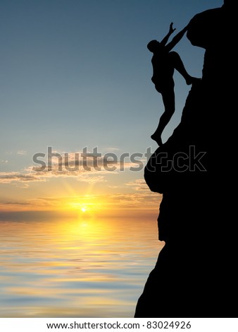 man on top of the mountain reaches for the sun