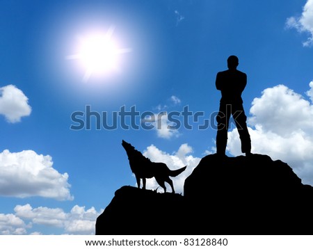 man and a wolf on a mountain top