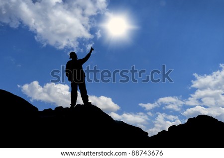 man on top of the mountain reaches for the moon