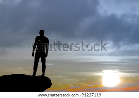 silhouette of a man on a mountain top fixed his gaze into the distance. natural composition