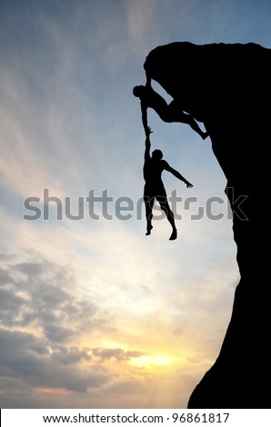 climber on the mountain holding another