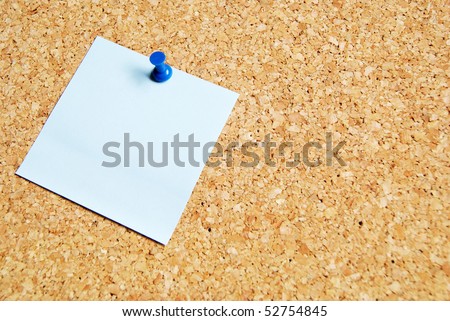 brown pin board with blue paper