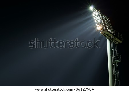 Stadium lights turned on and some insects at night