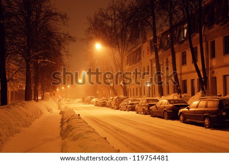 Street covered with snow at night