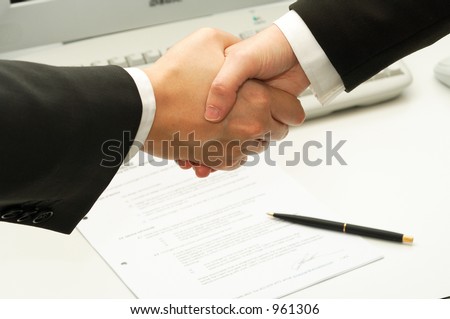 business man shake hands after signing a contract