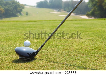 Golf teeing off with a driver