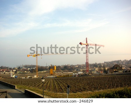 Rural renovation: construction cranes over rural farmland