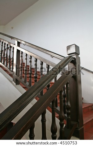 stock photo : Wooden stairways with dark wood railings white walls