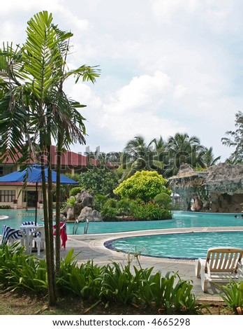 Swimming pool in a tropical resort with rock garden