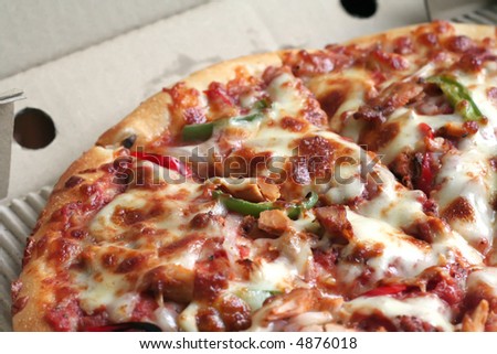 Sliced whole cheese and meat pizza in the box